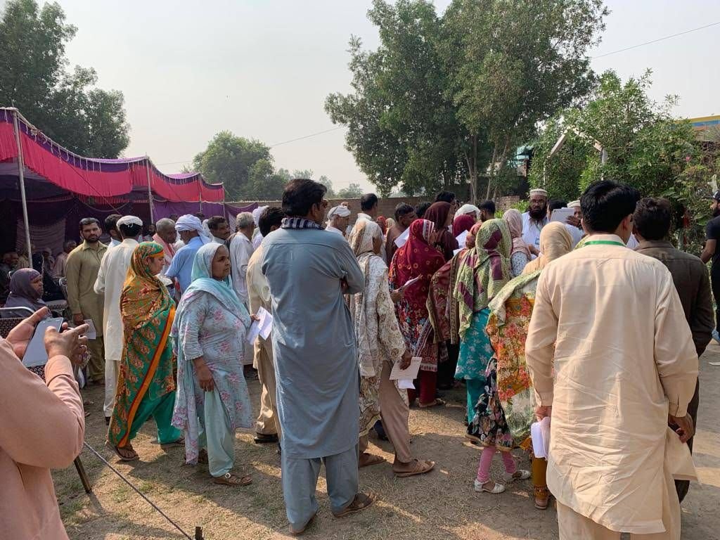 Crowds of people arriving outside the camp marquee