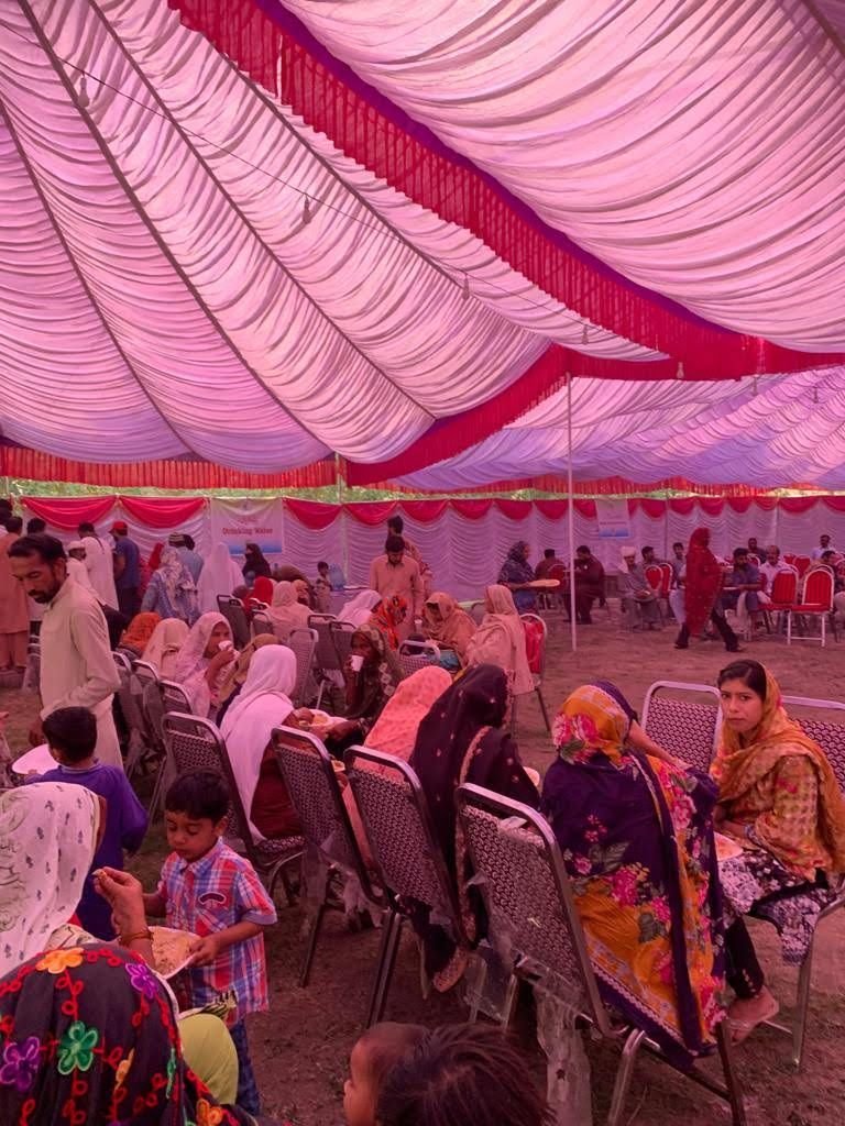 Families seated in the waiting marquee