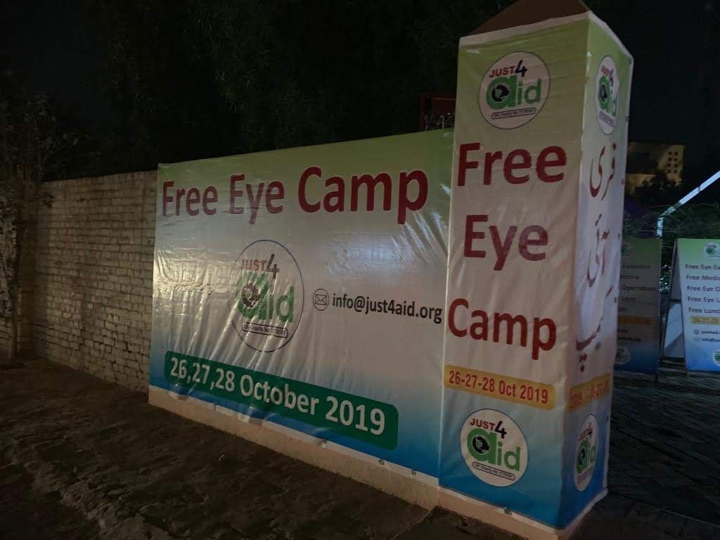 Free Eye Camp signage lit up at night