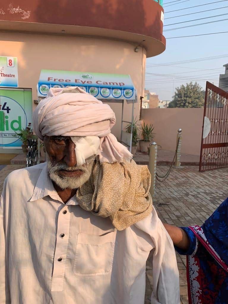 An elderly man wearing a protective eye patch after his free cataract operation