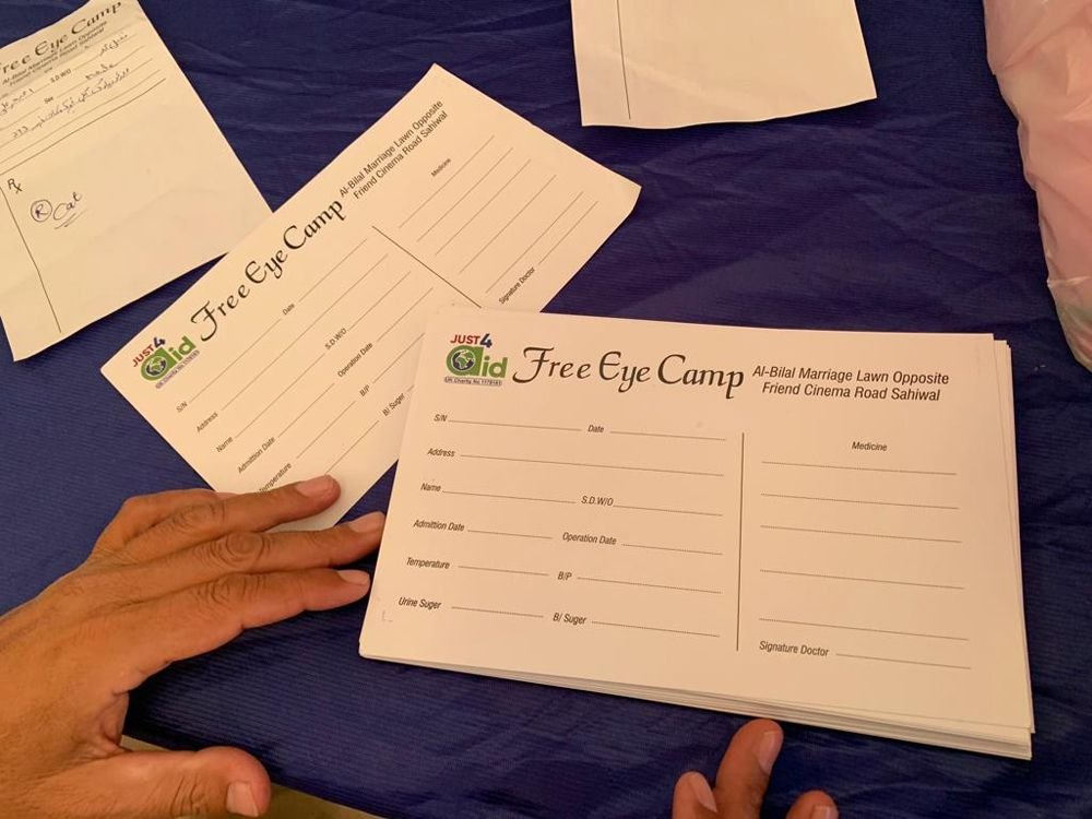 A stack of Free Eye Camp patient registration cards