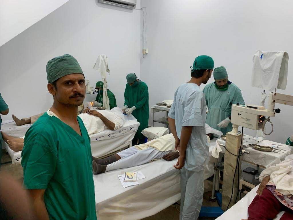 The surgical team in the operating theatre with patients on beds