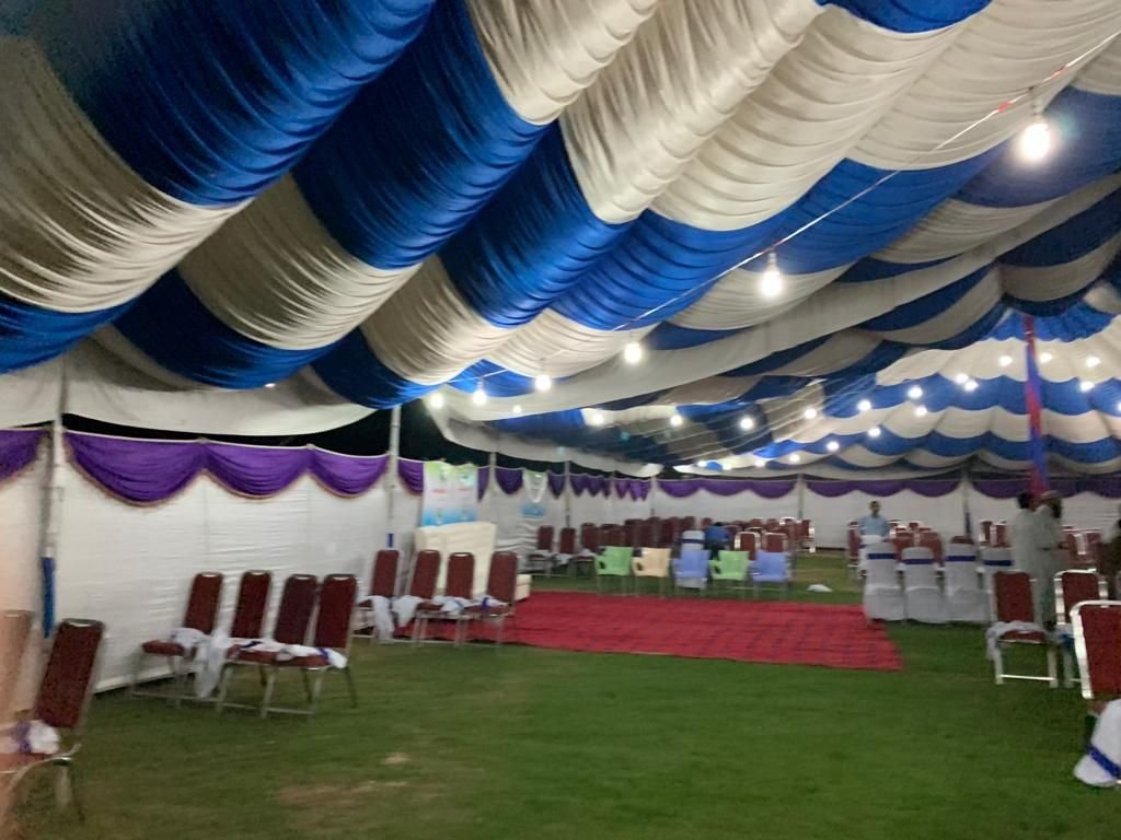 The empty marquee with rows of chairs, set up before the camp opened